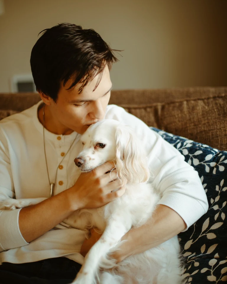 Andres holding his dog at home